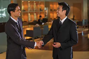 Thirty Prints: Businessmen shaking hands in bar