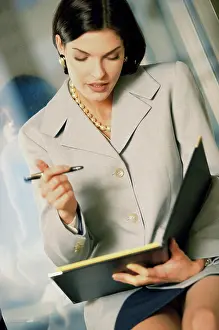 Business Suit Prints: Businesswoman holding a file and a pen