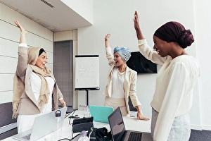 Small Group Of People Prints: Businesswomen raising arms together