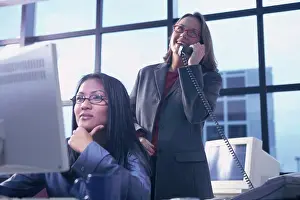 Businesswomen Prints: Two businesswomen working in an office