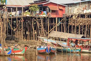 South East Asia Prints: Cambodia, Siem Reap. Houses on stilts and boats in the water