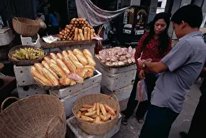 Southeast Prints: Cambodia, Siem Reap, Market Stall Selling Bread With Vendor And Customer