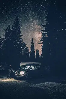 Shining Prints: Canada, British Columbia, Chilliwack, man with torch at minivan at night