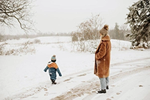 Babyhood Prints: Canada, Ontario, Mother and son on snowy road