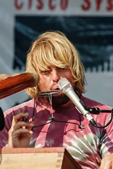 Ottawa Prints: Canada, Ontario, Ottawa. Australian musician Xavier Rudd plays a harmonica at Bluesfest