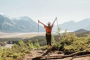 Hike Prints: Canada, Whitehorse, Rear view of woman with hiking poles in landscape