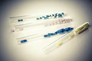 Interaction Prints: Capsules and pills in test tubes