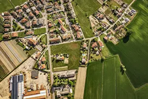 Crops Prints: Captivating aerial perspective of a quaint village nestled amidst the lush