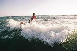 Refreshing Prints: Carefree moment as a person dives into the waves