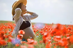Beginnings Prints: Carefree pregnant woman in sunny, idyllic rural red poppy field