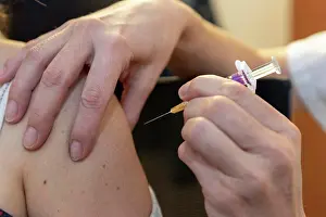 Vaccine Prints: a caregiver is about to vaccinate a patient