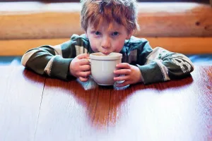 Unwind Prints: Caucasian boy drinking hot chocolate