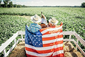50 54 Years Prints: Caucasian children holding American flag on hay ride