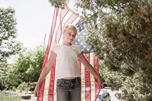 Caucasian girl posing with American flag