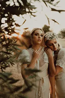 Relaxation Prints: Charming slim brides with flowers in garden with olive trees