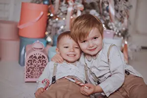 Home Prints: Cheerful cute children boys opening gifts under christmas tree