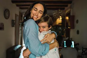 Relaxed Prints: Cheerful mother hugging her son