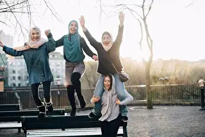 Stockholm Prints: Cheerful multi-ethnic female friends enjoying against clear sky