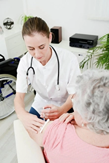 Disability Prints: Cheerful young woman doctor giving vaccine injection to elderly woman at home