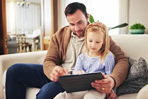 Cartoon Prints: Child, dad and a tablet for learning in a family home while reading or playing a game for education