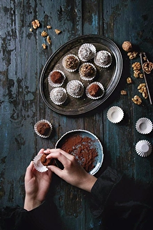 Assortment Prints: Child hands make homemade dark chocolate truffles with cocoa powder