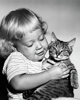 Cheerful Prints: Child holding cat, studio shot