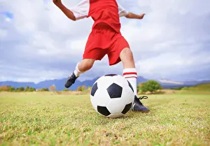Foot Prints: Child, kicking and soccer ball on green grass for sports