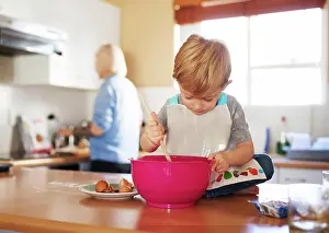 Eggs Prints: Child mixing, mom and baking together in kitchen for development