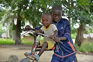 Looks Into The Camera Prints: Two children with a bicycle, Nkala, Bandundu Province, Democratic Republic of the Congo
