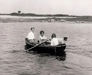 Paddle Prints: Three children with dog sitting in rowing boat