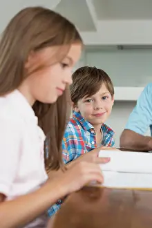 Groups Of People Prints: Children doing homework with their grandfather