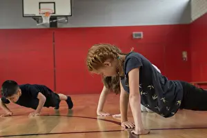Balance Prints: Children doing press-ups in sports hall, Munich, Bavaria, Germany