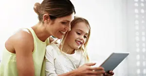 Child Development Prints: Children, family and tablet for education or learning with mother and daughter in home for research