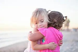 Pink Prints: Children play together on San Onofre Beach. California, USA