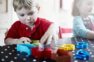Adjusting Prints: Children playing with shapes on table