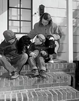 Loyalty Prints: Children sitting with dog on steps