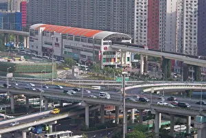 Autos Prints: China, Shanghai, Light Railway train leaving Caoxi Road station in south Shanghai in the early morning with cars