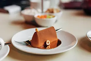 Dekoration Prints: Chocolate cake on a plate Chocolate cake on a plate is on the table