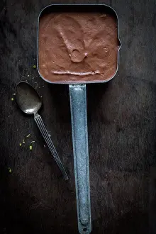 Dessert Prints: Chocolate mousse in vintage tin pot on dark wooden ground.Top view