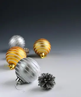 Decorations Prints: Christmas background with glass bauble ornaments and pine cones