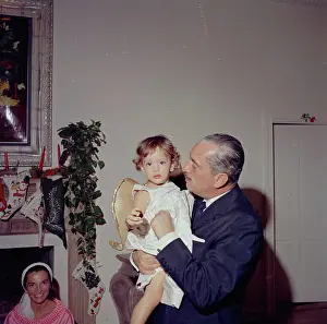 Michael Prints: Christmas Day, Palm Beach. Prince Stanislaus Radziwill of Poland holds his daughter