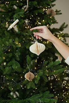 Holidays Prints: Christmas tree with Christmas toy decorated by woman