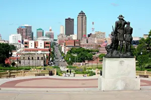 Skylines Prints: Chuck Haney Statue with Skyline in Background