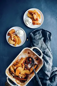 Dessert Prints: Cinnamon baked apple slices in a baking pan accompanied by two white plates with baked apple slices