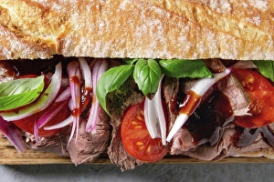 Back Ground Prints: Close up of beef baguette sandwich with tomatoes, basil, red onion. Flat lay, space