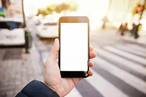 Computers Prints: Close up mans hand showing mobile phone with white screen display road