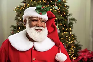 Person Of Color Prints: Close up portrait of a Black man with natural white beard dressed as Santa Claus
