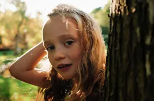 close up portrait of a child at golden hour in the forest