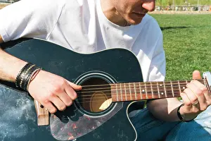 Portable Prints: close up of a singer playing guitar in a garden during a sunny day