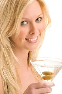 Studio Shots Prints: Close-up of an attractive blonde woman holding a martini glass with olives
